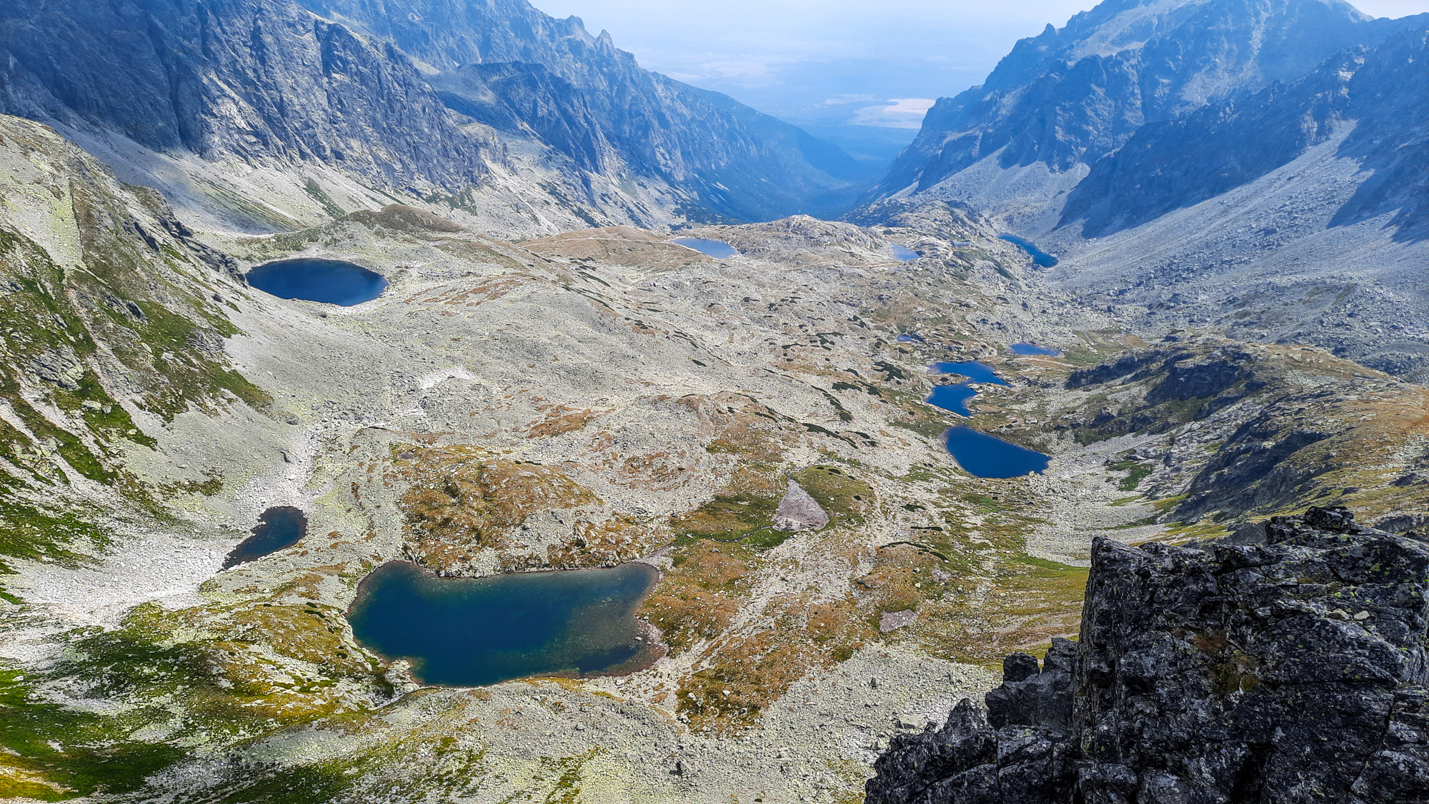 Množstvo plies vo Veľkej Studenej doline, Pusté plesá dole, Ľadové pleso vľavo, Zbojnícke plesá vpravo, v pozadí Starolesnianské pleso, Sesterské pleso a Dlhé pleso.